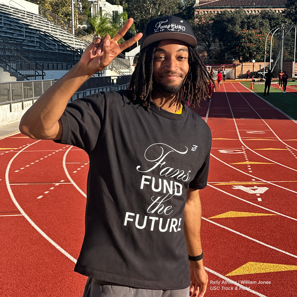 Person wearing a t-shirt with 'Fans Fund the Future' on a track and field background